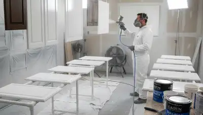 Professional cabinet painting process in New Orleans LA with smooth spray finish for kitchen renovation